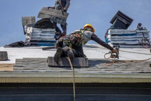 Inspector examining roof flashing and underlayment on a residential home during a permitted roof replacement.